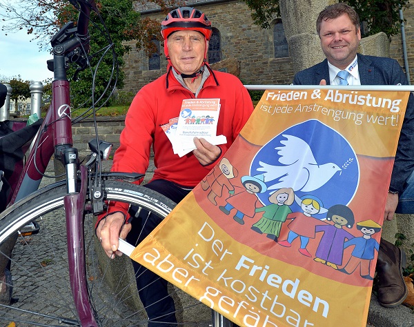 Hermann Reeh startet in Gebhardshain zur Benefizradtour nach Den Haag. Manuel Weber vom Vorstand der Volksbank Gebhardshain unterstützt ihn. Pro Kilometer gibt es einen Euro. (Foto: privat)