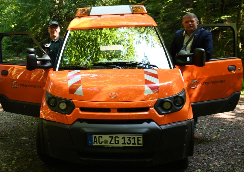 Juergen Weis (l.) und Stefan Zimmer (r). Am E im Nummernschild erkennt man das E-Fahrzeug. Foto: Landesforsten RLP