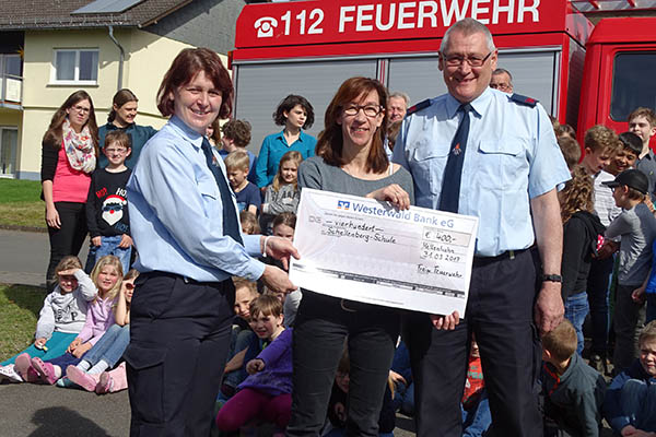 Sie strahlen bei der Spendenbergabe um die Wette. Die kommissarische Schulleiterin der Grundschule Anja Pfeil-Stickel (Mitte) und die Vertreter des Frdervereins der FFW Hellenhahn-Schellenberg  Isabelle Schmidt-Beyer und Hubert Schmidt. Fotos : Willi Simon