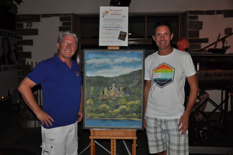 Sren Filipczak (rechts) erhielt den Zuschlag fr 500 Euro und ist neuer Besitzer des Gemldes Schloss Arenfels. Reiner Pertzborn, Vorsitzender 1000 Jahre Bad Hnningen e.V., gratulierte ihm herzlich. Foto: Charlotte Eisenbach