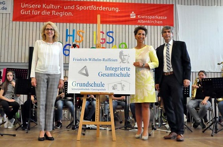 (v re.)Brgermeister Henrichs und die Leiterin der Grundschule Julia Fuchs berreichten ein neues Schild an Schulleiterin Andrea Brambach-Becker (Foto: kk)