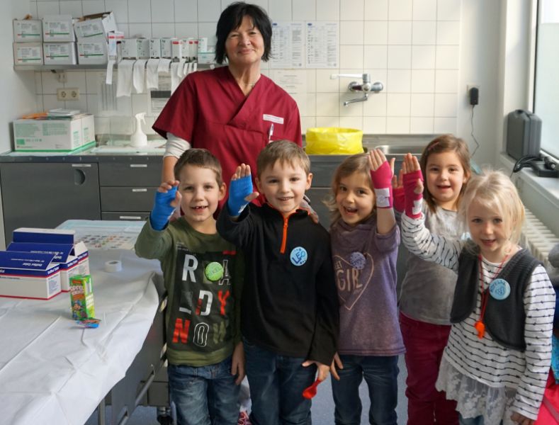 Strahlend zeigen die Kinder die bunten Verbnde mit Aufklebern, die ihnen Heike Oerlemans angelegt hat. Foto: privat