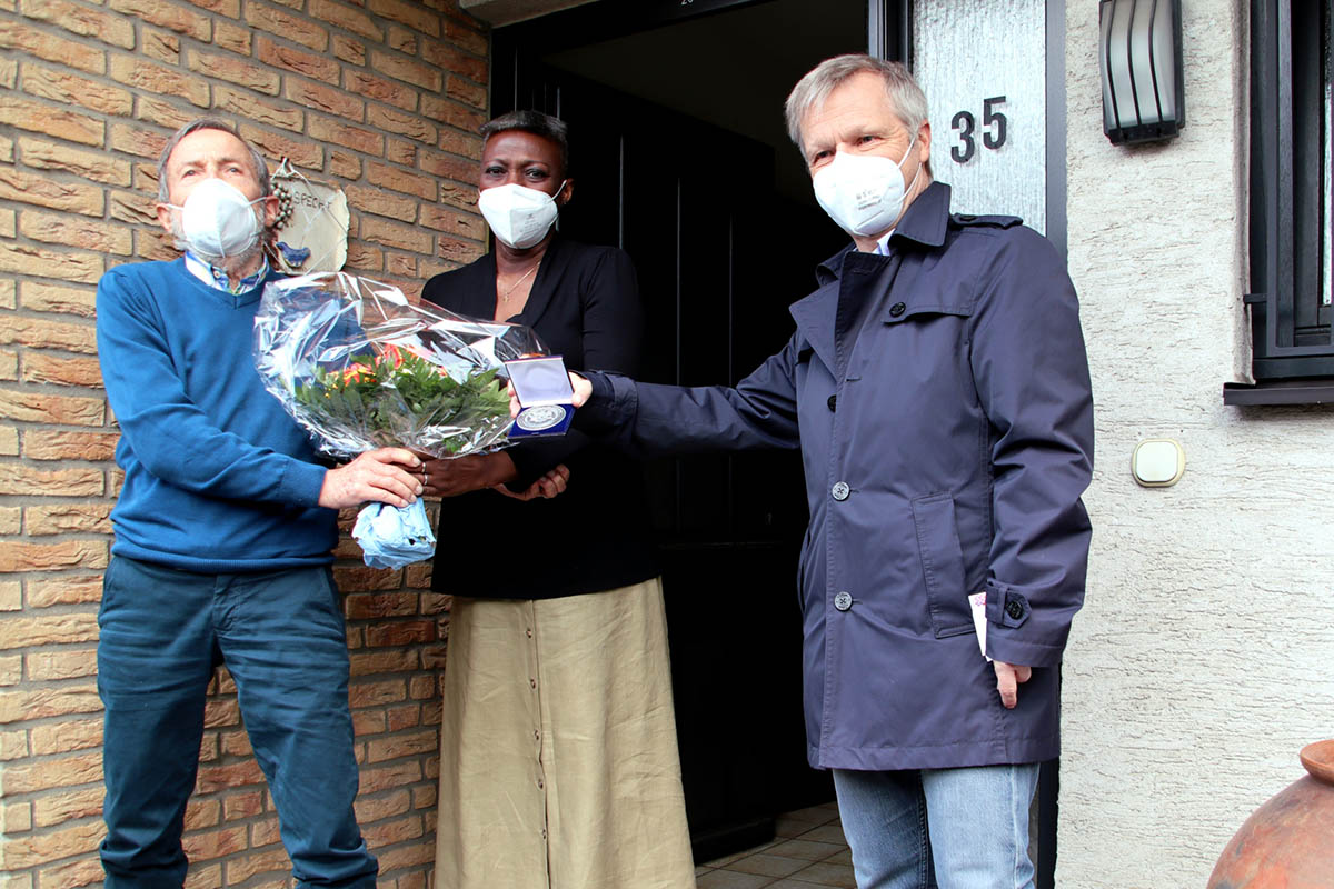 Brgermeister Otto Neuhoff berreichte Ernst Specht (links) die Dankmedaille fr Brgerengagement und Traditionspflege. ber den Blumenstrau freute sich Fanta Tortor Sesay-Specht  seit 40 Jahren mit Ernst Specht verheiratet. Foto: Stadt Bad Honnef