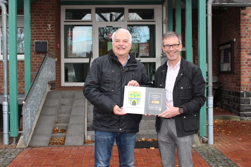 Weihen den WLAN-Punkt offiziell mit einem Hinweisschild ein: Brgermeister Jrgen Held (links) mit EVM-Kommunalbetreuer Norbert Rausch. Quelle: EVM
