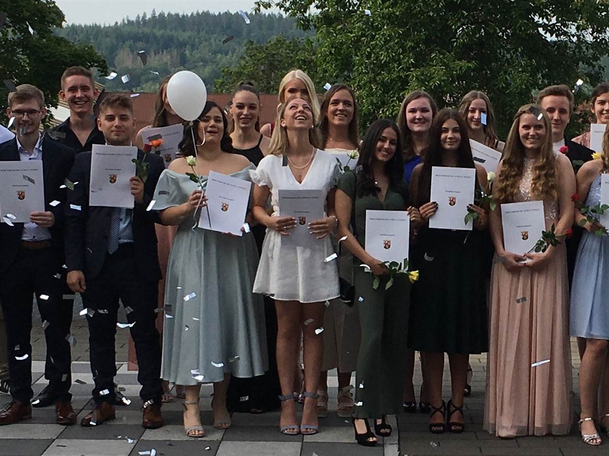 Gruppenfoto mit Zeugnissen und Konfetti. (Foto: BBS Wissen) 