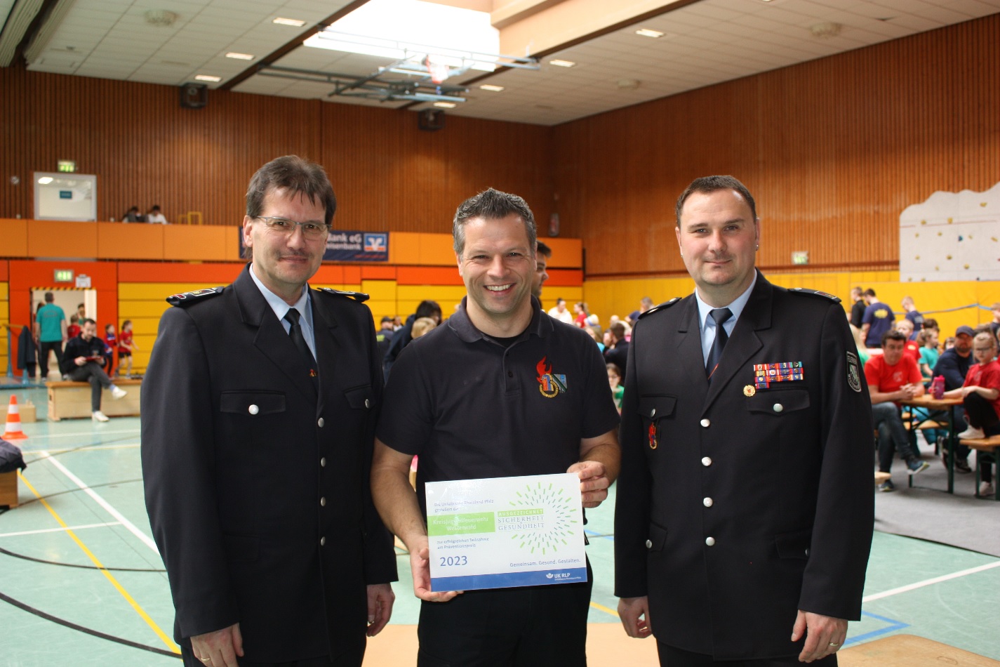 Kreisjugendfeuerwehrwart Thomas Krekel (v.l.), Geschftsfhrer Dirk Strder und der stellvertretende Kreisjugendfeuerwehrwart Florian Bach nahmen die Plakette zum Prventionspreis in Empfang. (Foto: Sebastian Mller)