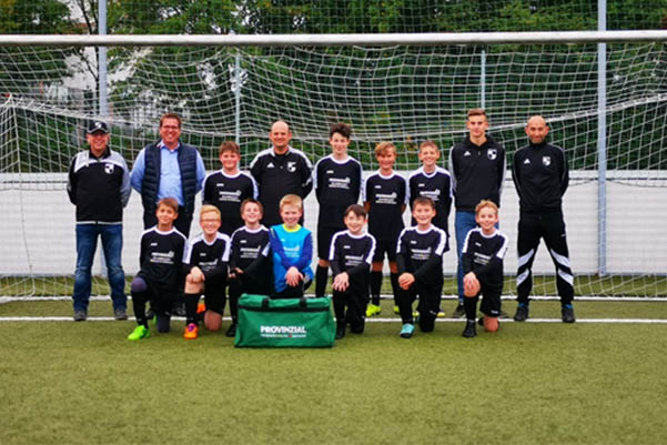 Von links: Helmut Hecking (Abteilungsleiter Fuball), Sandro Gdtner (Sponsor), Marc Stefan Henrich (Jugendkoordinator D- und C-Jugend), Jan Hilbers (Co-Trainer), Heiko Lindner (Trainer) sowie die Kids der D-Jugend in den neuen Trikots. Foto: Verein